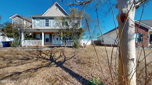 view of front of home with a porch and a front lawn