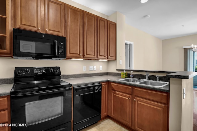 kitchen with kitchen peninsula, sink, black appliances, and an inviting chandelier