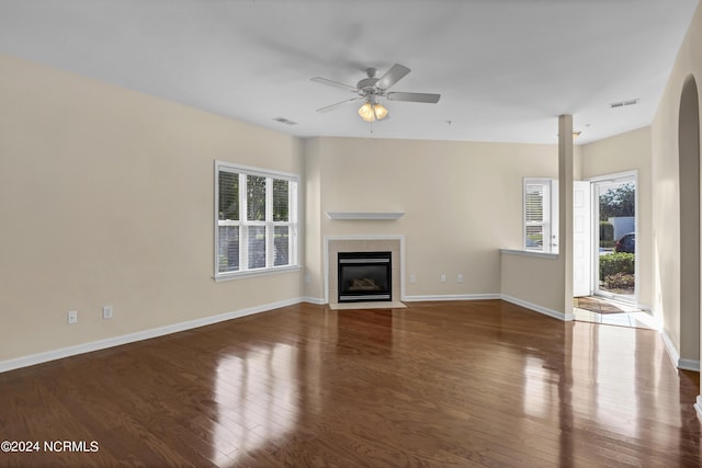 unfurnished living room featuring visible vents, ceiling fan, wood finished floors, and a healthy amount of sunlight