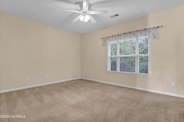 empty room with light carpet and ceiling fan