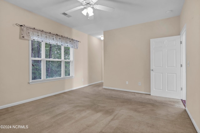 empty room with light carpet and ceiling fan