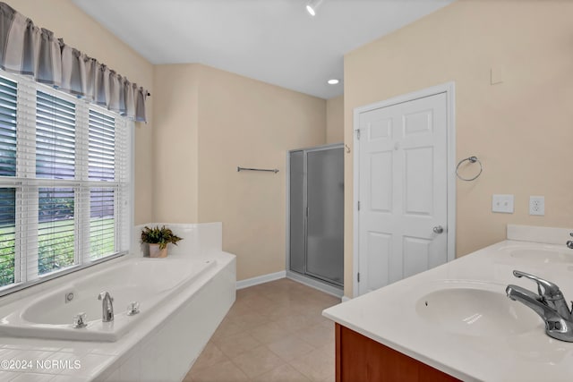 bathroom featuring tile patterned flooring, shower with separate bathtub, and vanity