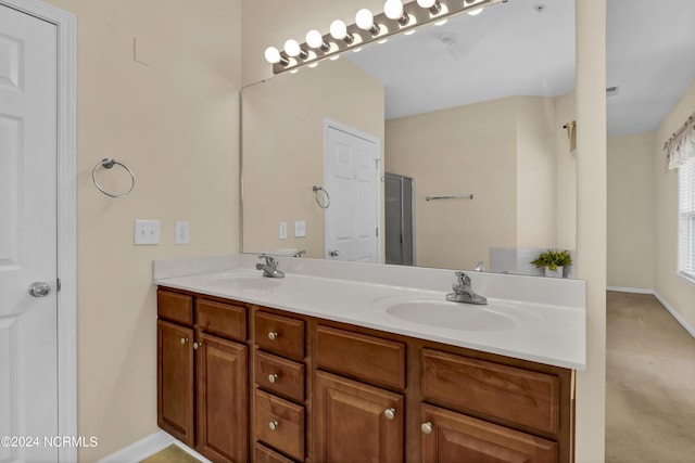 bathroom with a sink, baseboards, and double vanity