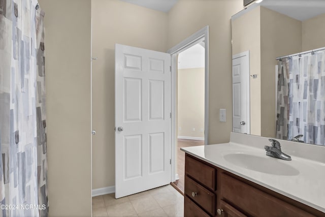full bathroom featuring vanity, baseboards, tile patterned floors, and a shower with shower curtain