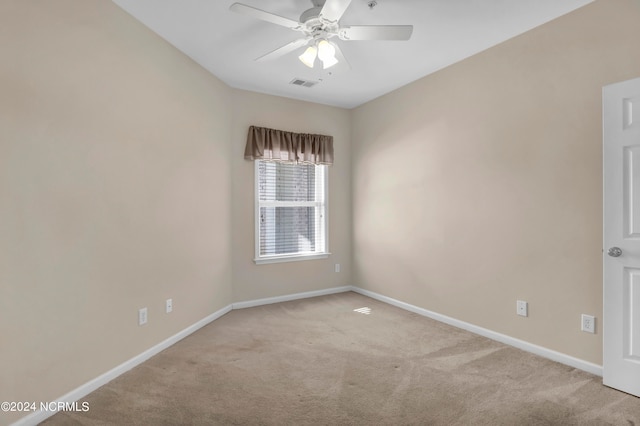 unfurnished room featuring ceiling fan and light colored carpet