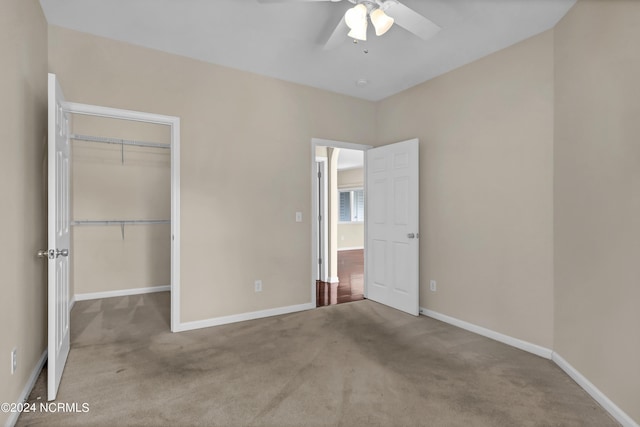 unfurnished bedroom with a closet, baseboards, ceiling fan, and carpet flooring