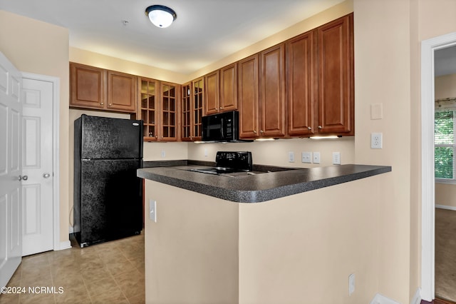 kitchen featuring kitchen peninsula and black appliances