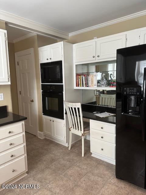 kitchen with white cabinets, black appliances, and crown molding