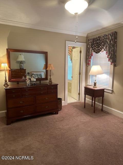 sitting room featuring light colored carpet and crown molding