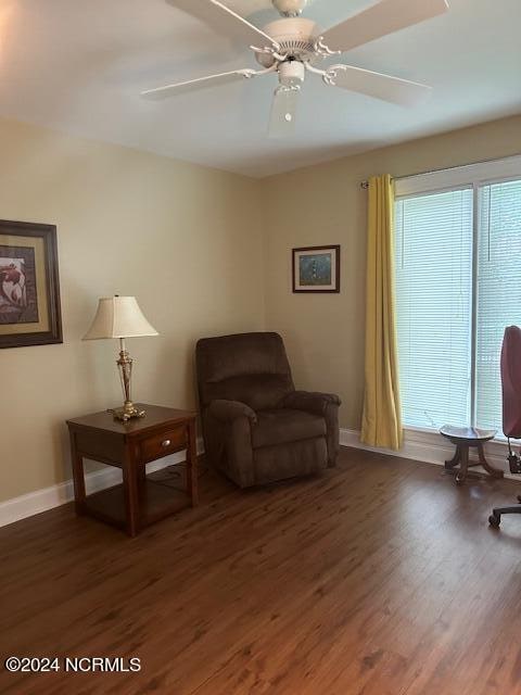 sitting room with ceiling fan and dark hardwood / wood-style floors