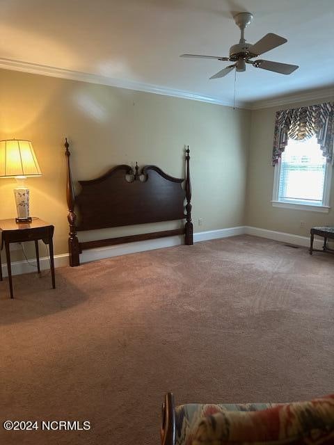 carpeted bedroom featuring ornamental molding and ceiling fan