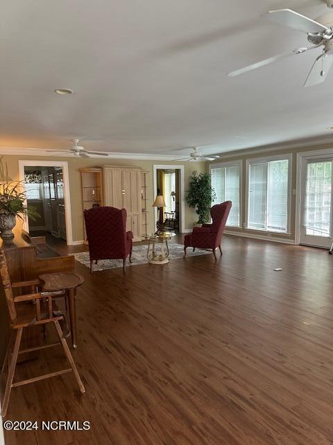 living room with crown molding and dark hardwood / wood-style flooring