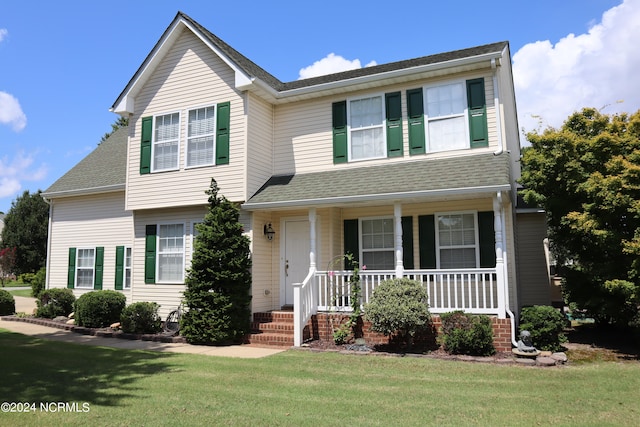 view of front of house with a porch and a front lawn