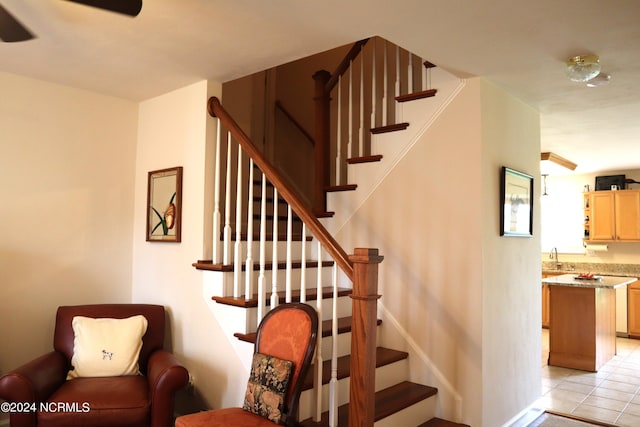 staircase featuring tile patterned floors