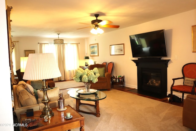 carpeted living room with ceiling fan