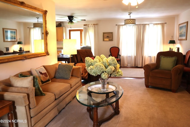 carpeted living room with ceiling fan