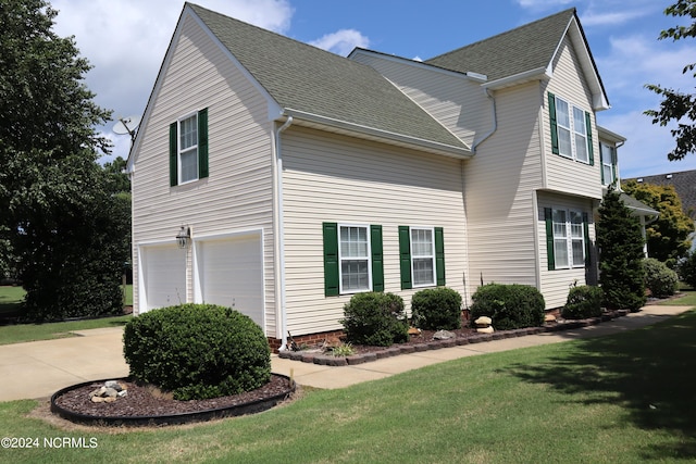 view of property exterior featuring a garage and a yard