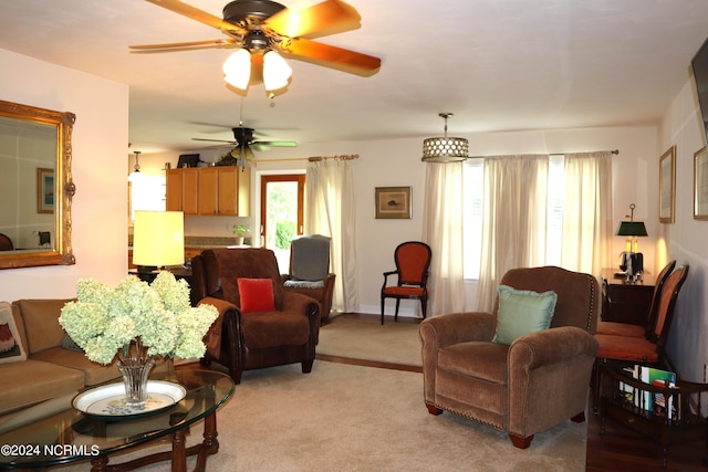 living room with ceiling fan and light colored carpet