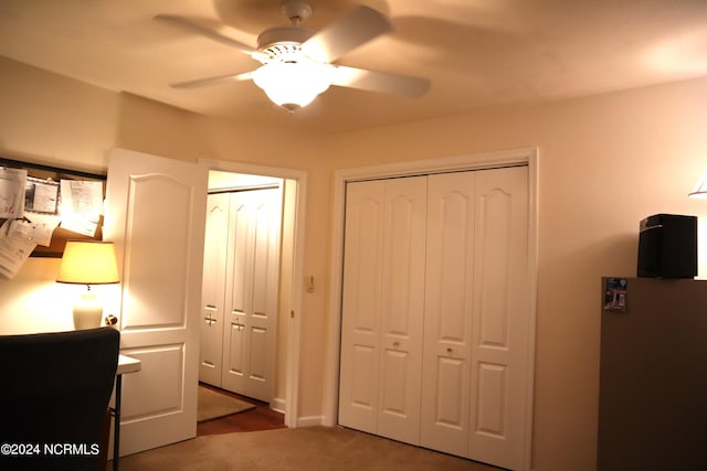 carpeted bedroom with multiple closets and ceiling fan