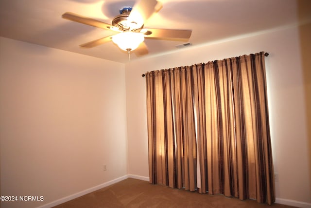 empty room featuring carpet and ceiling fan