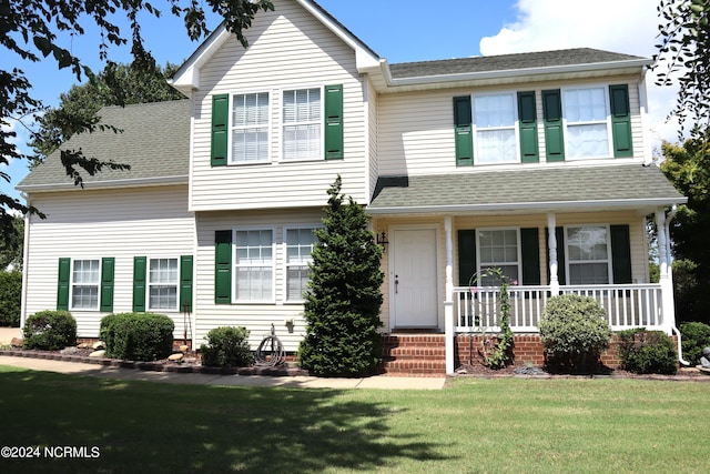 view of front of home with covered porch and a front yard