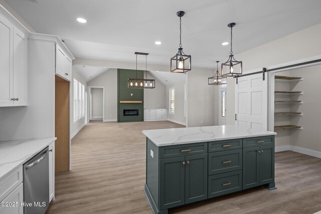 kitchen featuring a barn door, white cabinetry, dishwasher, and pendant lighting