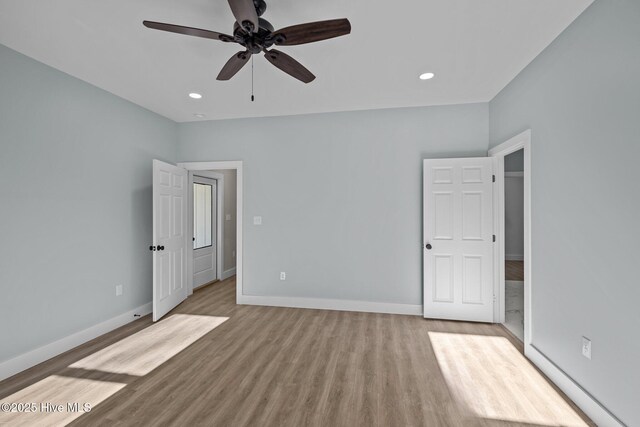 unfurnished bedroom with ceiling fan and light hardwood / wood-style flooring