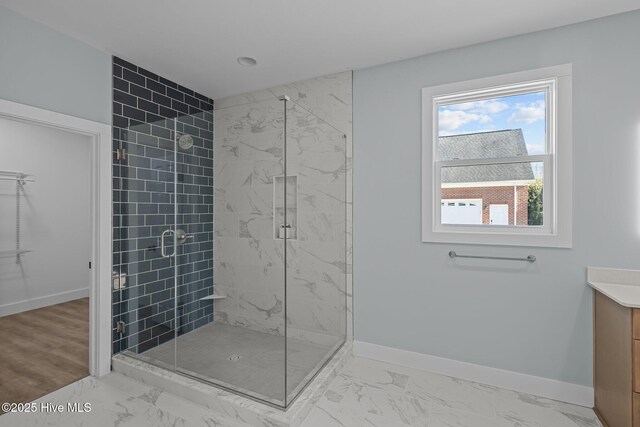 bathroom with vanity and a shower with door