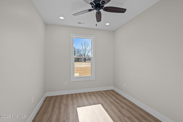 empty room featuring ceiling fan and light hardwood / wood-style flooring