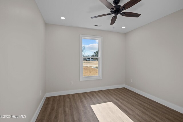 empty room featuring ceiling fan and hardwood / wood-style flooring