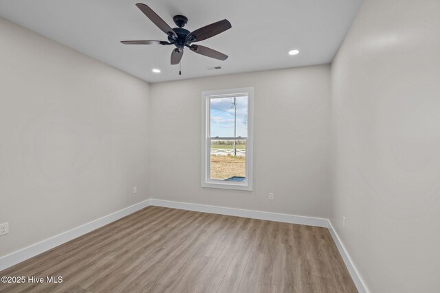 unfurnished room with ceiling fan and light wood-type flooring