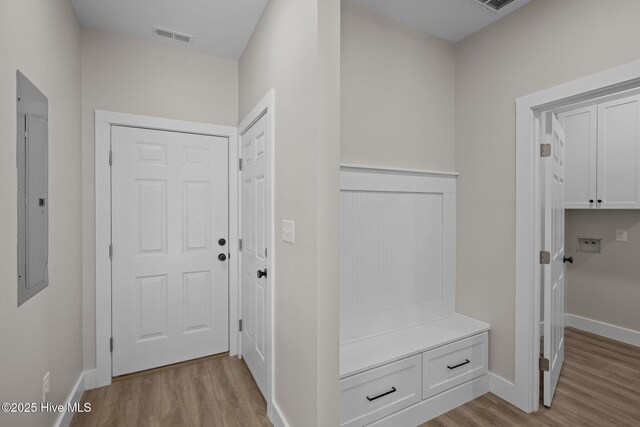 mudroom with electric panel and light wood-type flooring