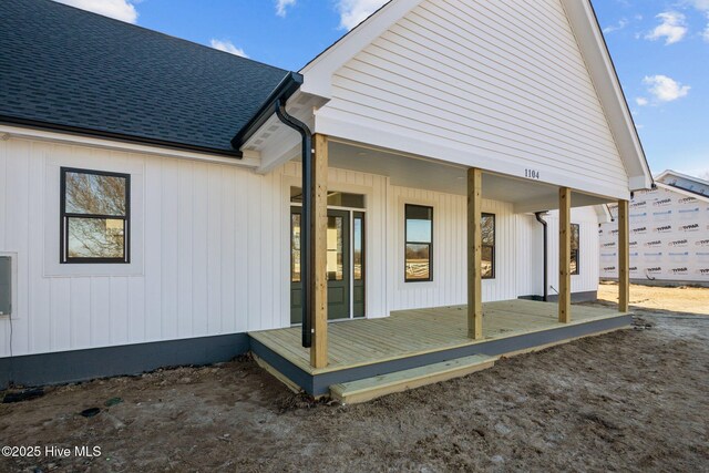 view of side of property featuring covered porch