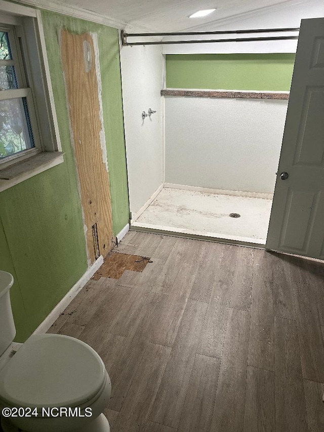 bathroom featuring hardwood / wood-style floors and toilet