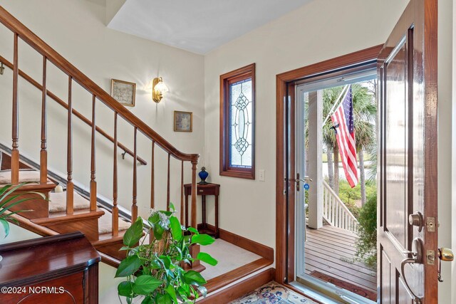 114 SW 21st St, Oak Island, NC 28465 - entrance foyer with stairway, a wealth of natural light, and baseboards