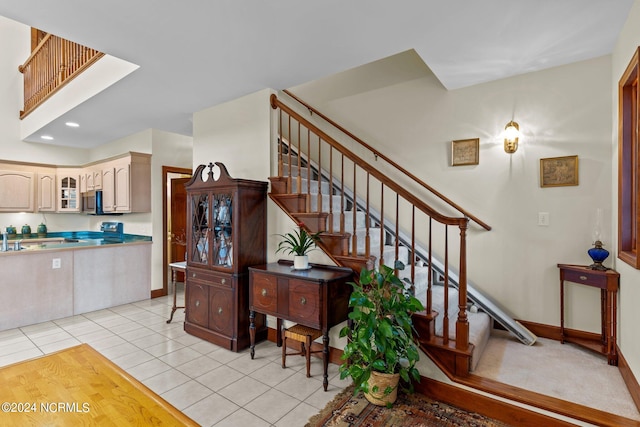 stairway with tile patterned floors