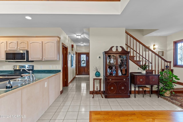 kitchen featuring light brown cabinets, appliances with stainless steel finishes, and light hardwood / wood-style floors