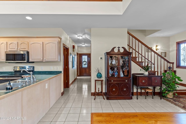 114 SW 21st St, Oak Island, NC 28465 - kitchen featuring light tile patterned floors, stainless steel appliances, baseboards, light brown cabinetry, and recessed lighting