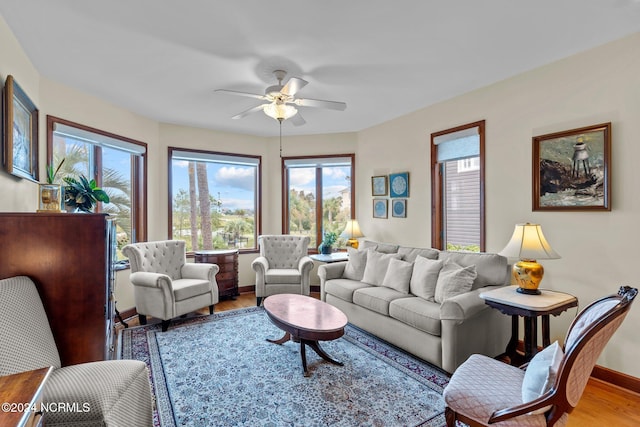 living room with light hardwood / wood-style floors and ceiling fan