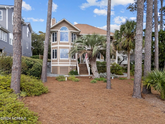 114 SW 21st St, Oak Island, NC 28465 - view of front of property with a chimney and stairs