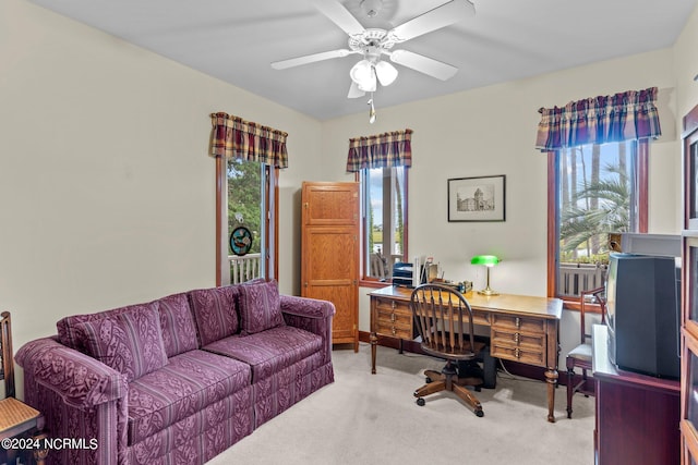 carpeted office with ceiling fan and plenty of natural light