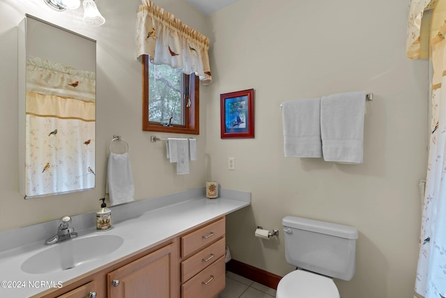 bathroom with toilet, tile patterned flooring, and vanity