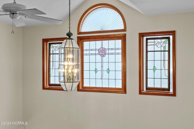 room details with ceiling fan with notable chandelier