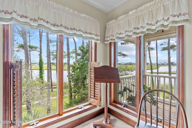 sunroom / solarium with a water view