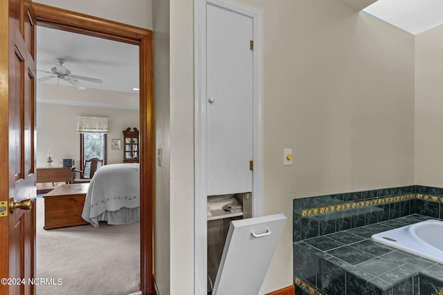 bathroom with a washtub and ceiling fan