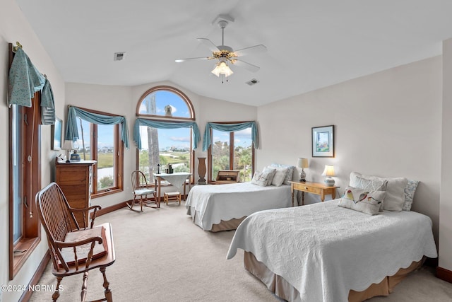 114 SW 21st St, Oak Island, NC 28465 - bedroom featuring visible vents, baseboards, vaulted ceiling, light carpet, and a ceiling fan