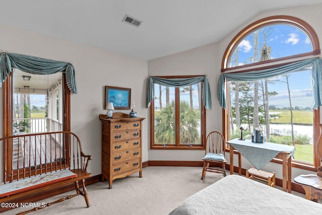 114 SW 21st St, Oak Island, NC 28465 - carpeted bedroom featuring lofted ceiling, visible vents, and baseboards