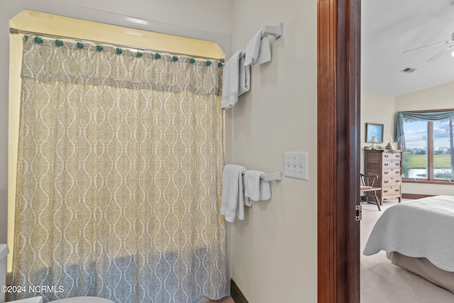 bathroom featuring ceiling fan, toilet, and a shower with shower curtain