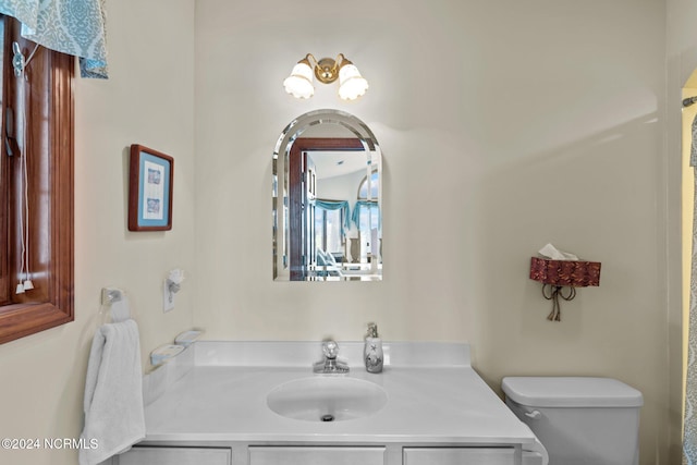 bathroom featuring toilet and vanity