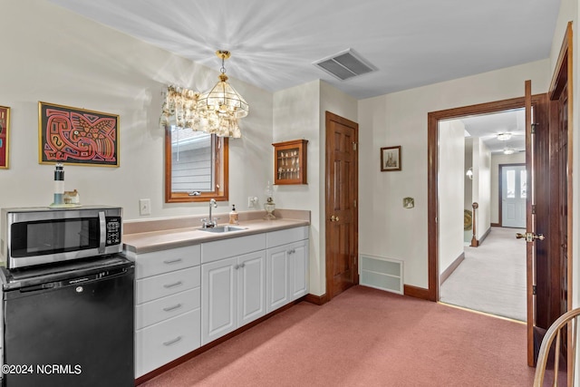 bathroom featuring plenty of natural light, sink, and a chandelier